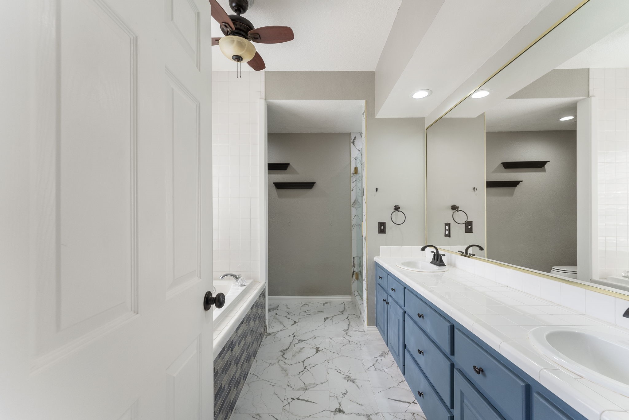 13942 Longstreet Road Willis, TX 77318 - Photo 14 of 46 a spacious bathroom with a double vanity sink a mirror and shower