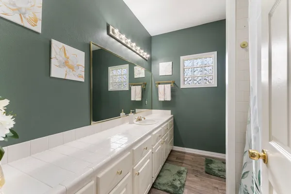 a spacious bathroom with a sink and a mirror