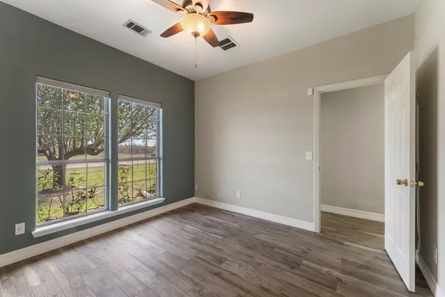 a kitchen with stainless steel appliances granite countertop a sink cabinets and wooden floor