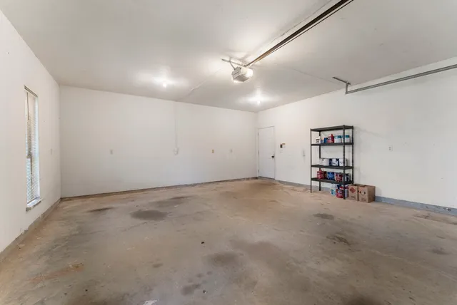 a view of kitchen with stainless steel appliances refrigerator stove and wooden floor