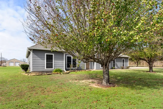 a front view of house with yard and green space