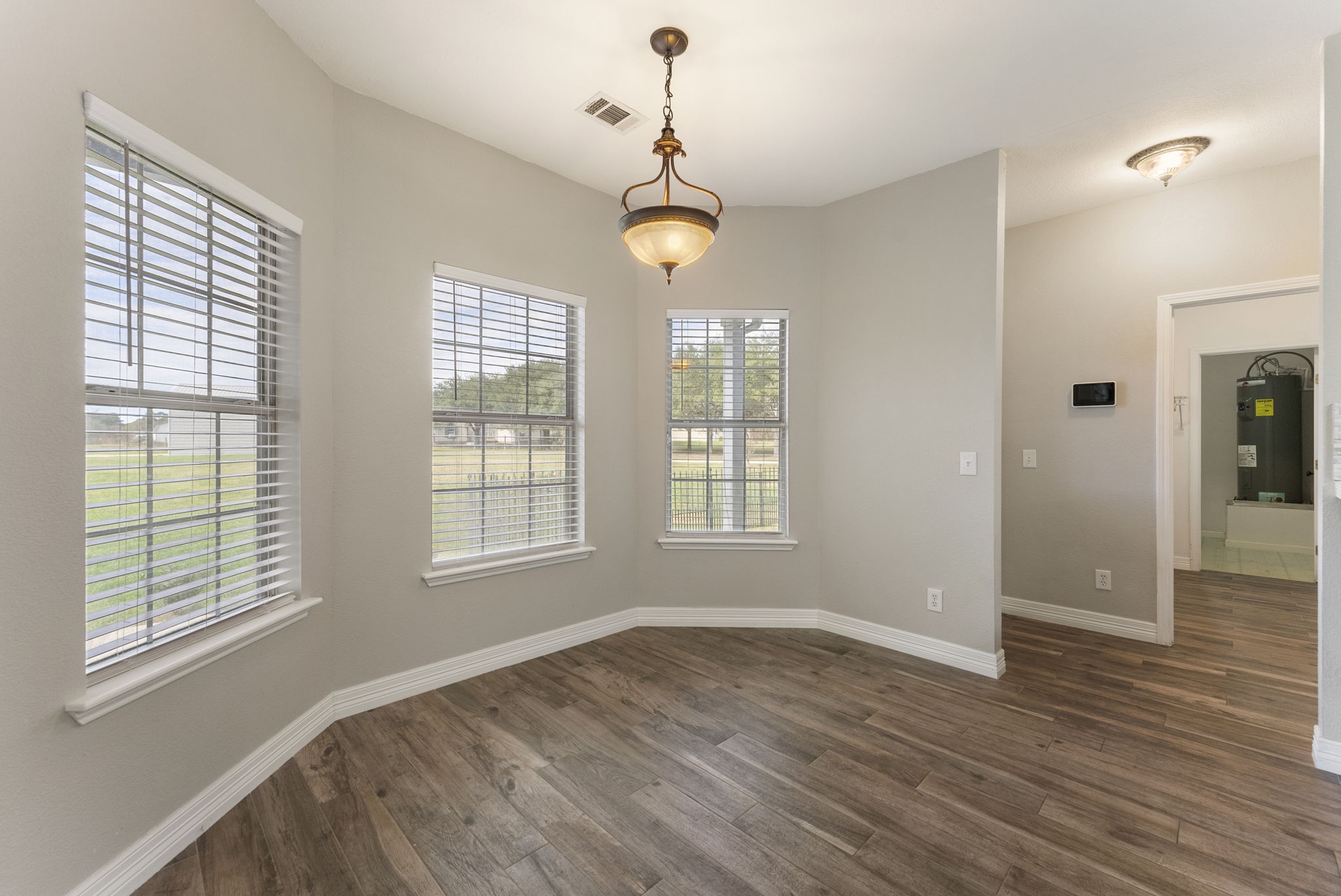 13942 Longstreet Road Willis, TX 77318 - Photo 32 of 46 a view of an empty room with wooden floor and windows