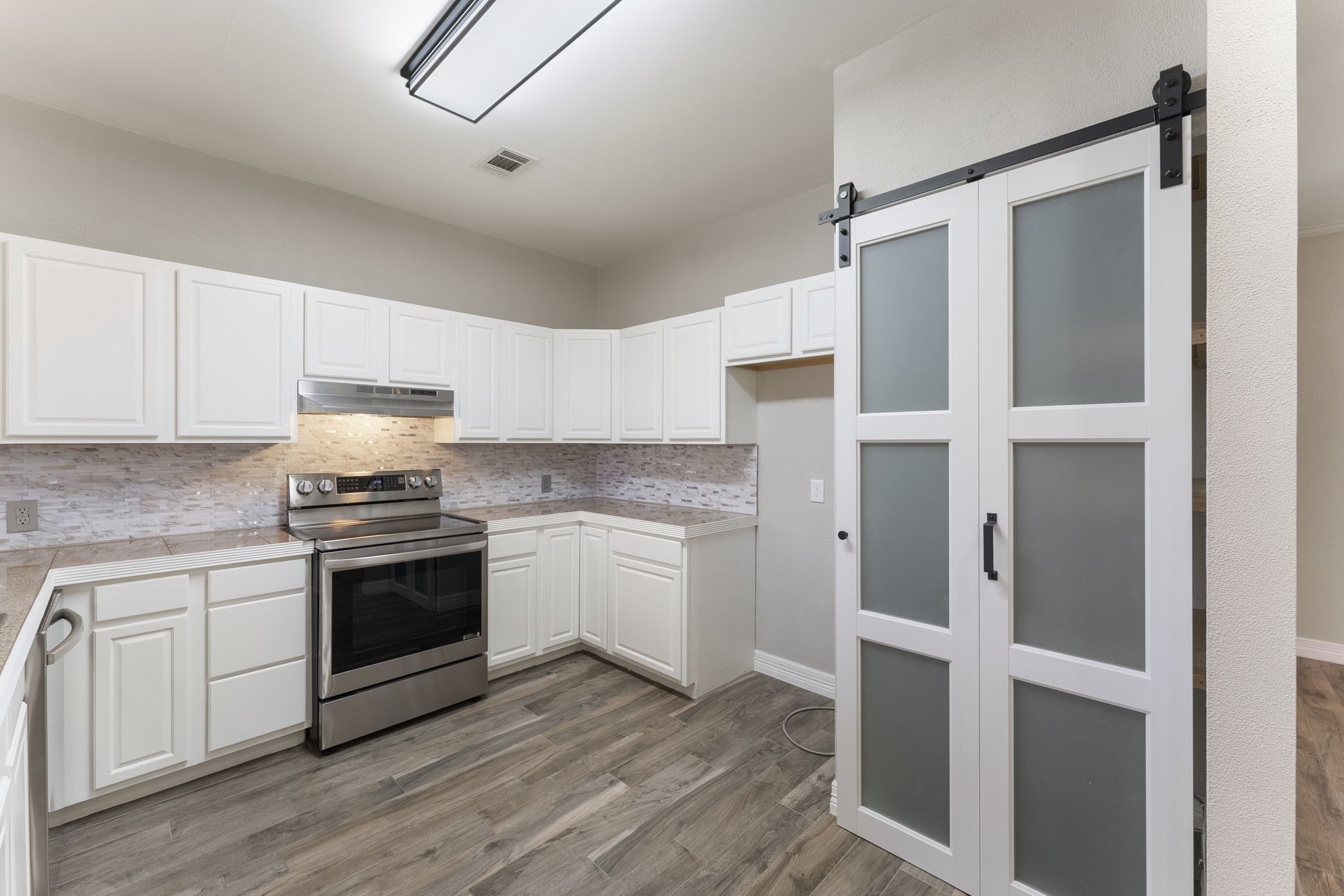 13942 Longstreet Road Willis, TX 77318 - Photo 34 of 46 a kitchen with stainless steel appliances granite countertop a stove and a refrigerator
