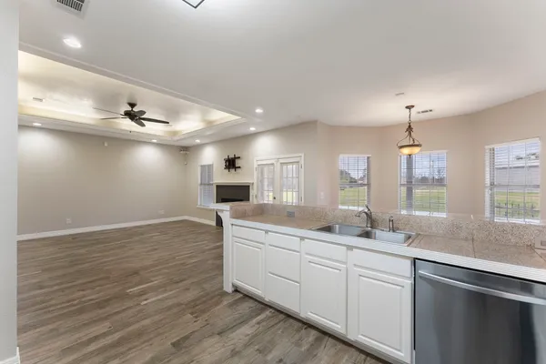 a kitchen with a sink cabinets and window