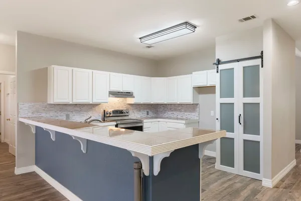 a kitchen with stainless steel appliances a sink stove and refrigerator