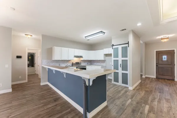 a kitchen with a stove a refrigerator and a sink