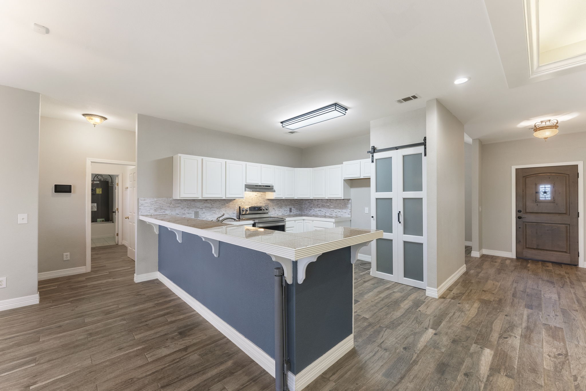 13942 Longstreet Road Willis, TX 77318 - Photo 40 of 46 a kitchen with a stove a refrigerator and a sink