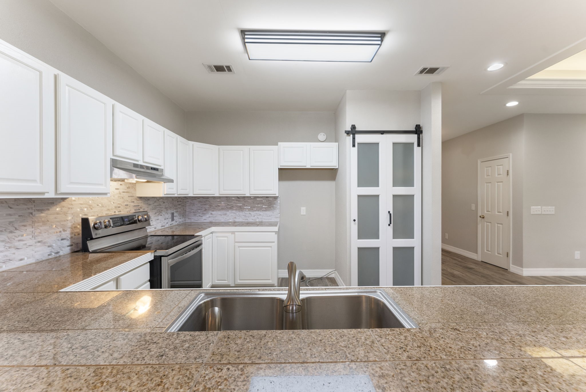13942 Longstreet Road Willis, TX 77318 - Photo 41 of 46 a kitchen with stainless steel appliances granite countertop a sink stove and refrigerator