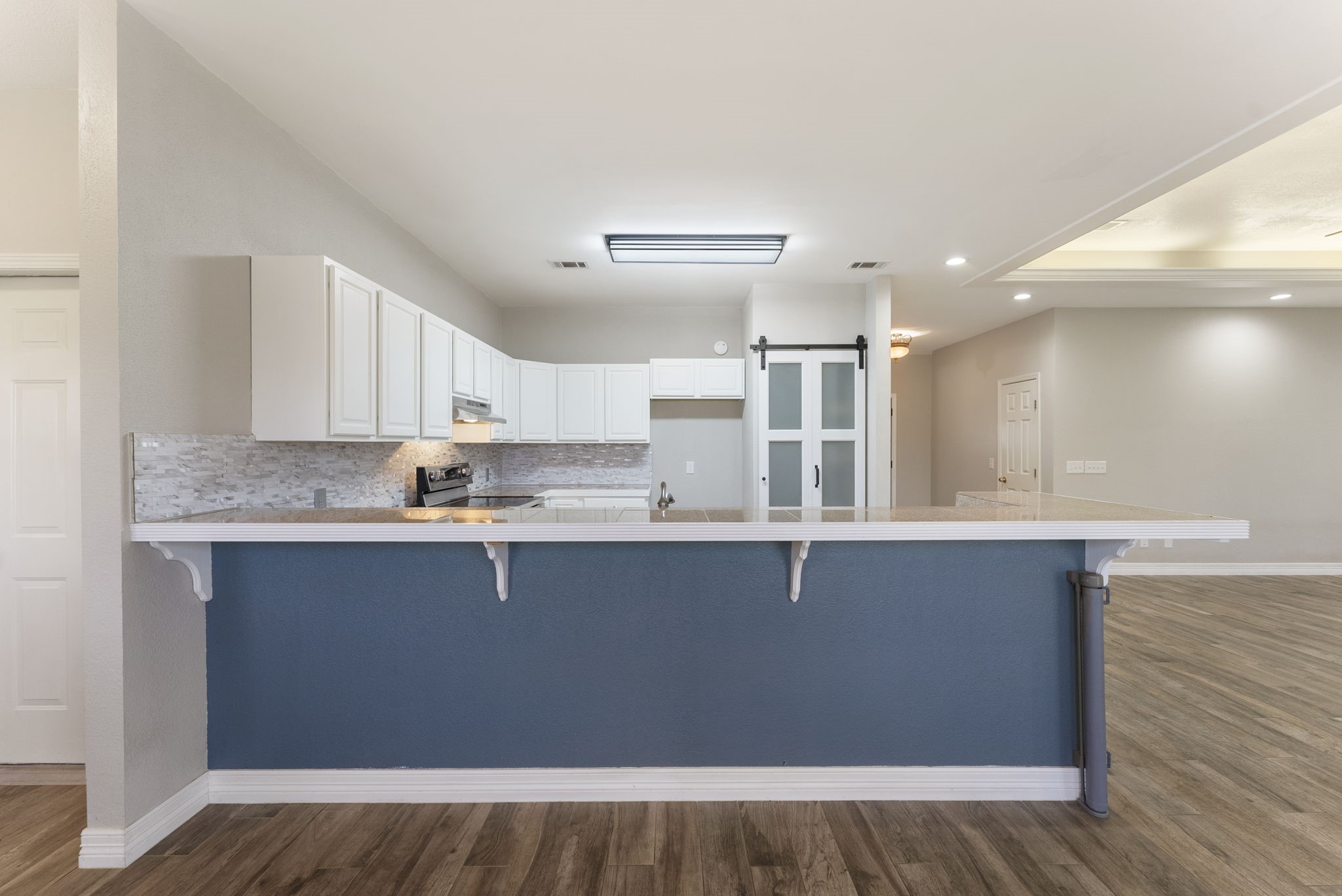 13942 Longstreet Road Willis, TX 77318 - Photo 42 of 46 a kitchen with stainless steel appliances granite countertop a sink cabinets and wooden floor