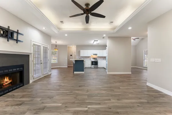 a view of kitchen and hall with wooden floor