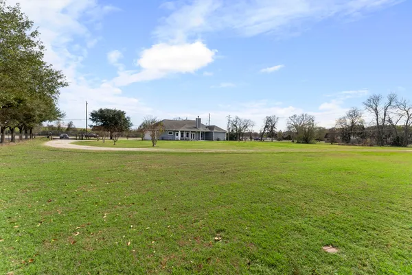 a view of a green field with sitting area