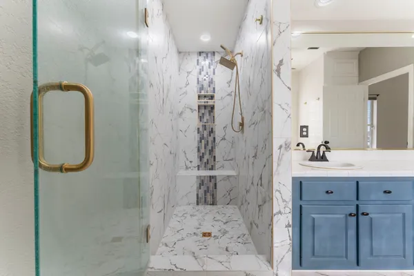 a bathroom with a sink a toilet and shower