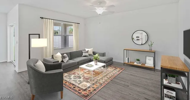 a living room with furniture a wooden floor and a window