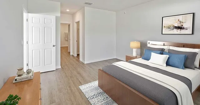 a bed room with a bed and a painting