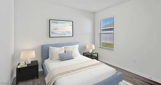 a bedroom with a bed and a lamp