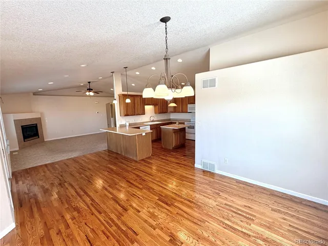 a view of a kitchen with wooden floor and staircase