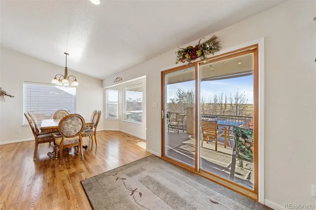 a view of a dining room with furniture wooden floor and chandelier