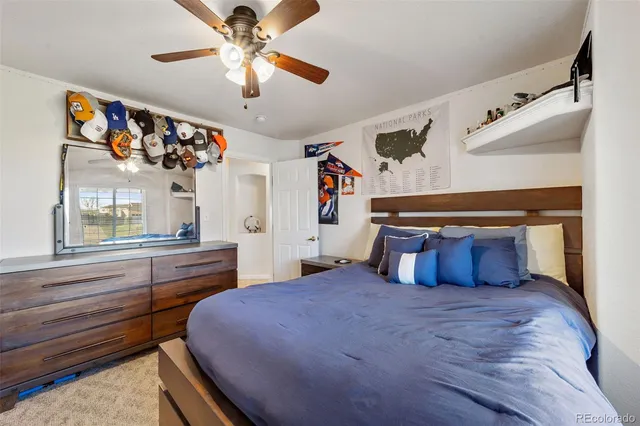 a bedroom with a large bed and a chandelier