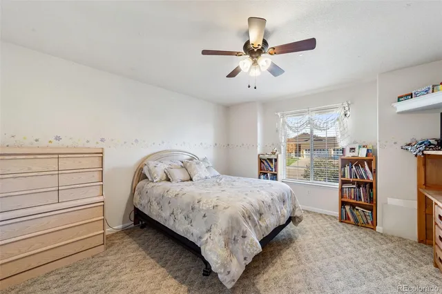 a bedroom with a bed and a book shelf