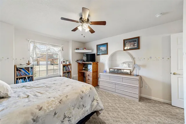a bed room with a bed and a view of kitchen