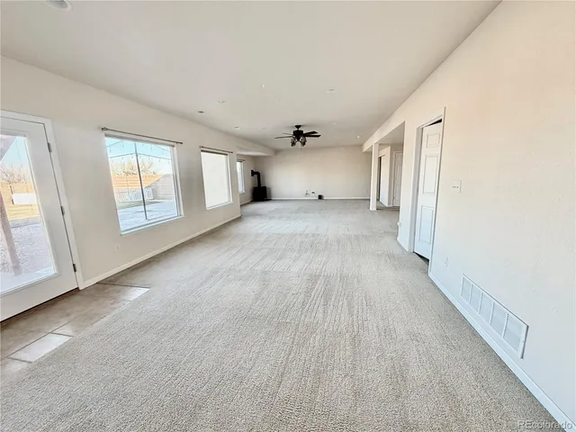 a view of a livingroom with wooden floor and window