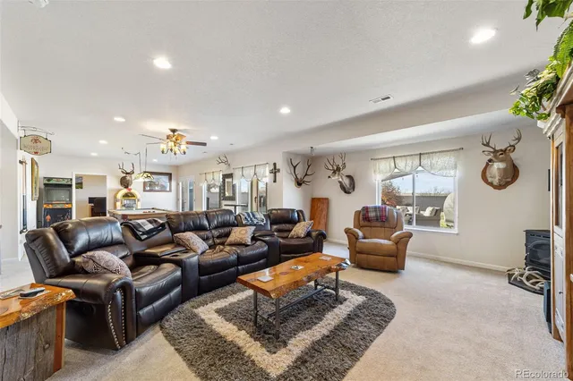 a living room with furniture ceiling fan and a rug