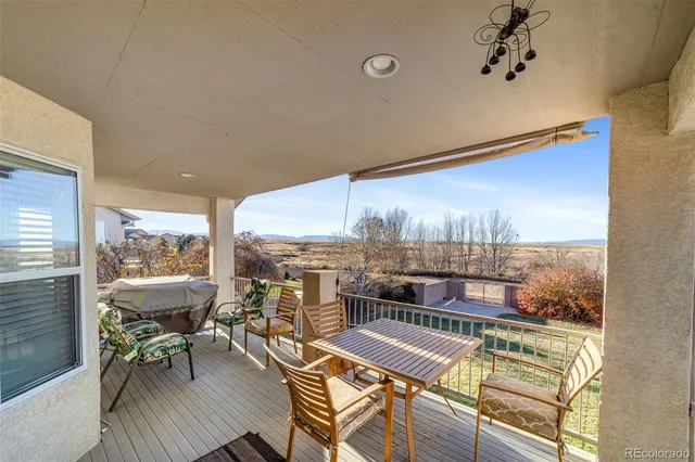 a view of a balcony with chairs and a table
