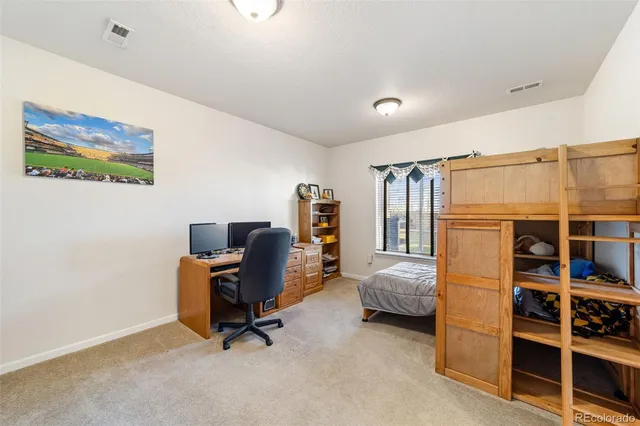 a bedroom with a bed and a desk