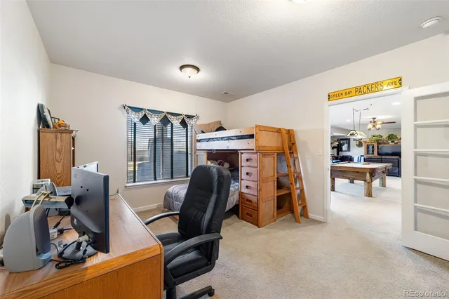 a bathroom with a toilet a sink a mirror a vanity and a shower