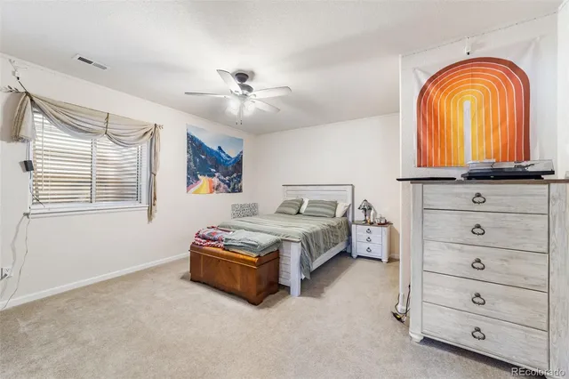a bedroom with furniture and a chandelier