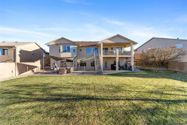 a front view of a house with a yard table and chairs