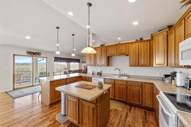 a kitchen with a sink a counter space appliances and cabinets