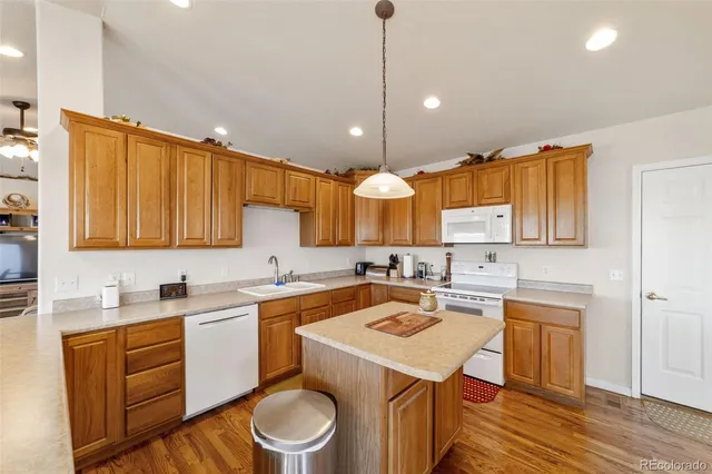 a kitchen with a sink a stove and cabinets