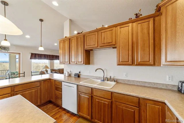 a kitchen with a sink a counter and cabinets