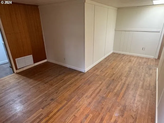 a view of a room with wooden floor