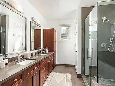 a bathroom with a double vanity sink and mirror