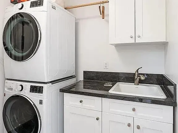 a close view of a sink and washer and dryer