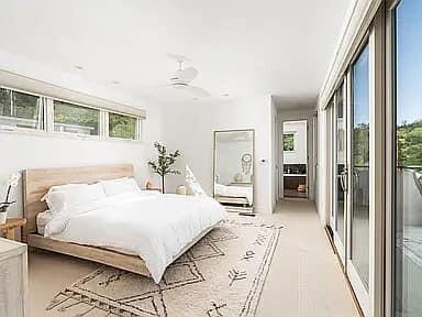 331 Sherman Road Santa Barbara, CA 93103 - Photo 13 of 18 a bedroom with a large bed and a chandelier