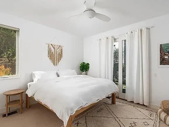 a bedroom with a bed dresser and a window