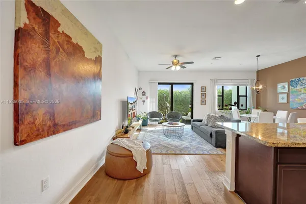a living room with furniture and wooden floor