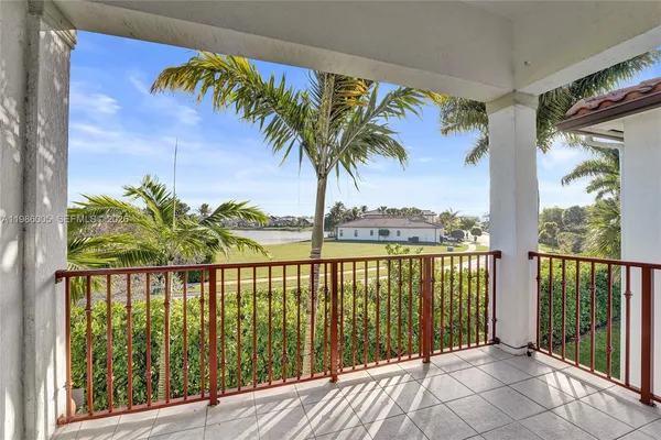 a view of a balcony with floor to ceiling windows with wooden floor