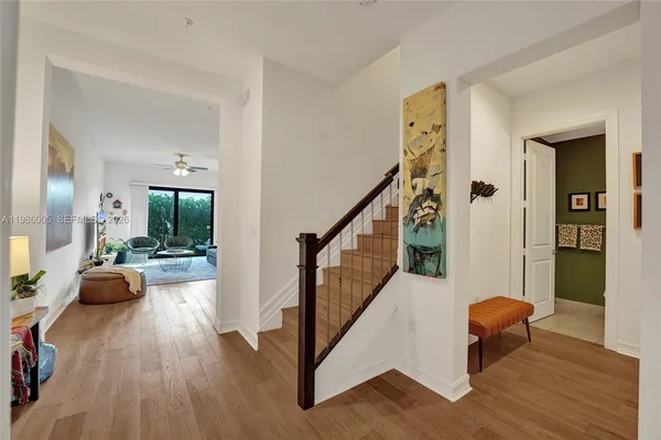 a view of a livingroom with furniture and hardwood floor