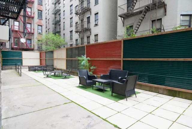 a backyard of a house with outdoor seating
