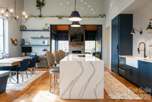 a large kitchen with a table and chairs