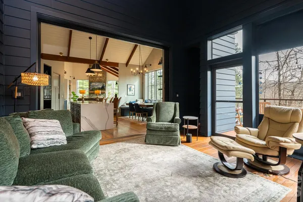 a living room with furniture a couch and large window