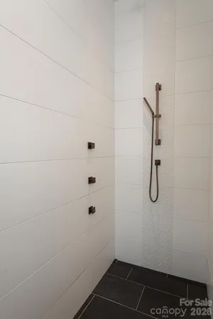 a bathroom with a glass shower door