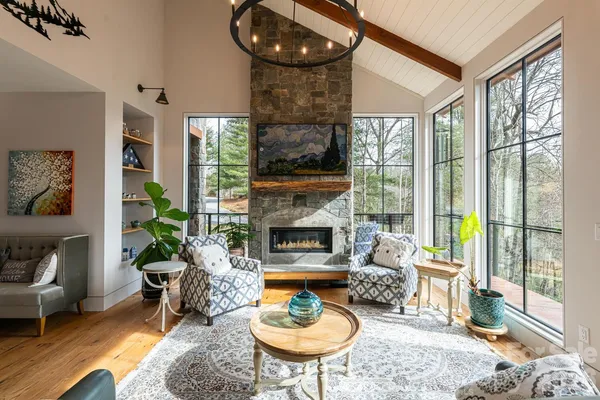 a living room with furniture a table and a fireplace