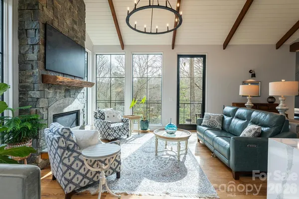 a living room with furniture a fireplace and a large window