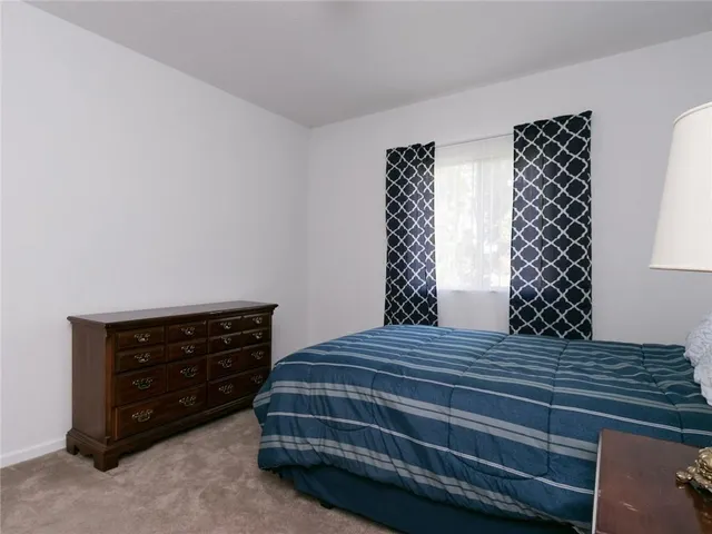 a bedroom with a bed and a lamp