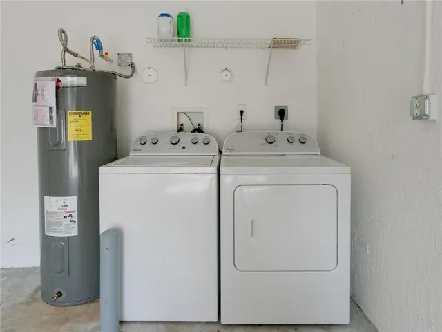 a view of a storage & utility room with refrigerator